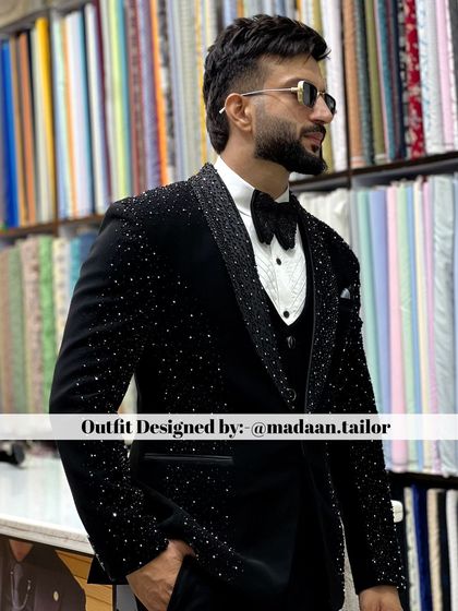 This client is ready for his reception in a black three-piece suit where the jacket is covered in shimmering crystals. The look is pure luxury and designed to stand out.
