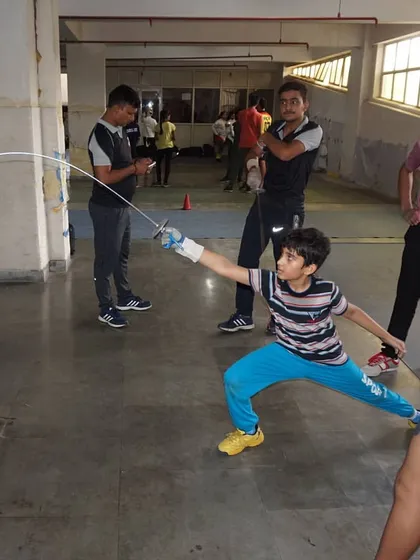 A young fencer executes a perfect lunge, hitting the target with precision. These drills build the muscle memory needed for competitive success.