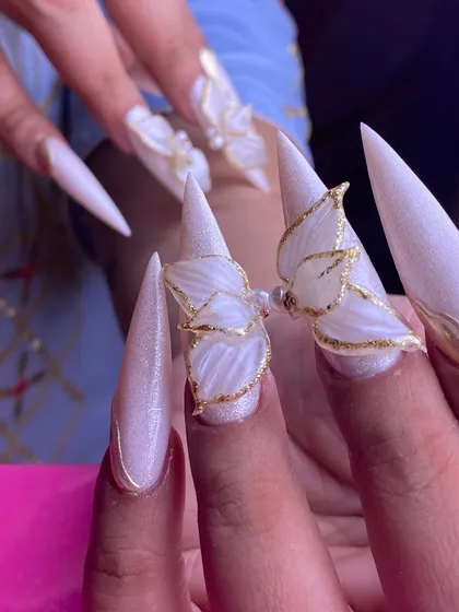 This is what I call wearable art. These long stiletto nails feature delicate, hand-sculpted 3D butterflies with gold leaf accents, perfect for a wedding or any special occasion where you want to make a statement.