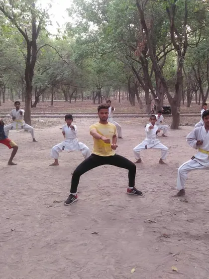Students practice their horse stance during an outdoor session. The focus and discipline remain the same, whether we are inside the dojo or out in the open.