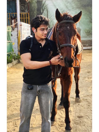 A quiet moment of connection between a rider and his horse before a lesson.