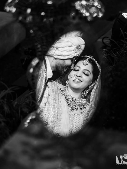 A reflection of joy. We used a mirror to capture this creative portrait of Priyanka and Sashwat, a candid moment where their smiles are amplified, showing the happiness they share.