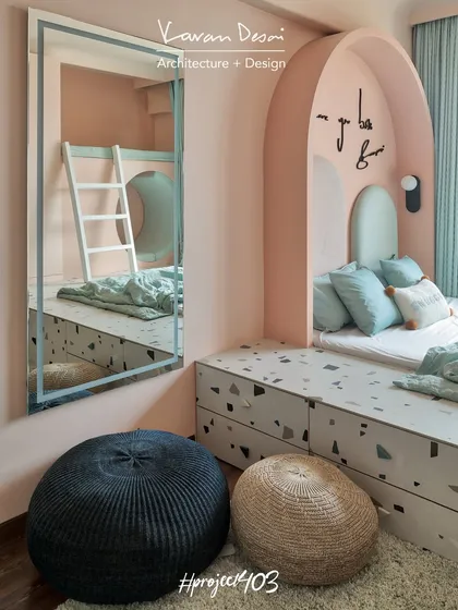 For this kid's room, we designed a fun yet practical space. The arched bed nook, terrazzo platform with hidden storage, and a loft bed accessed by a ladder make it a personal playground. It’s about creating a room that grows with them.