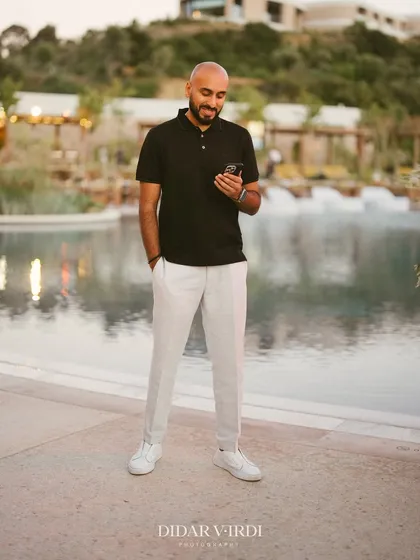 A candid shot of me checking my phone by the pool in Greece. Even on the road, I'm always connected and planning the next move.