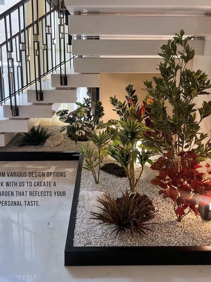 Another perspective of the faux garden, showing how the arrangement fits perfectly within the custom black-trimmed planter. We design each garden to seamlessly integrate with your home's existing architecture.