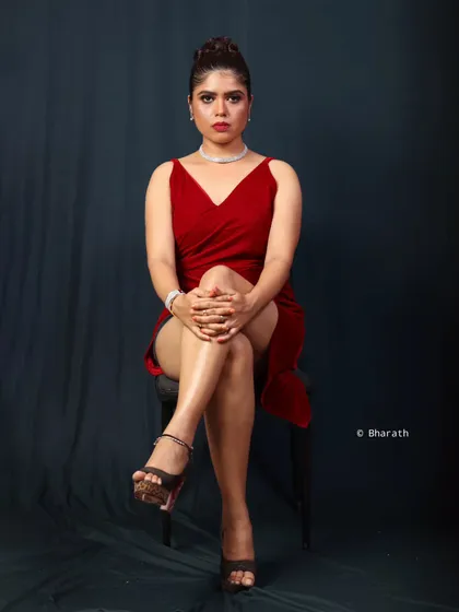 A powerful studio portrait featuring a modern, chic red dress. I used a single light source to create dramatic shadows and highlight the clean lines of the outfit and the model's confident expression, perfect for a contemporary lookbook.