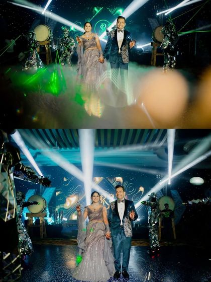 The couple makes a grand, smoky entrance at their Sangeet in Pattaya, flanked by performers. A truly spectacular start to the night.