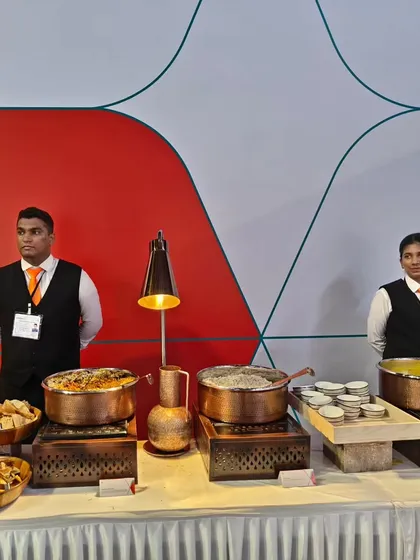 Our professional staff ready to serve at the Air India X launch event. The setup features traditional Indian copperware to align with the 'Gourmair' theme, reflecting a fusion of heritage and modern service.