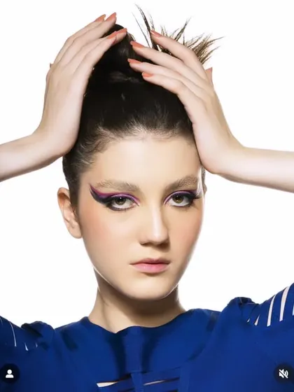 This look is all about precision. I created a sharp, dramatic winged eyeliner using a vibrant purple for a clean and bold graphic makeup style suitable for fashion portfolios.