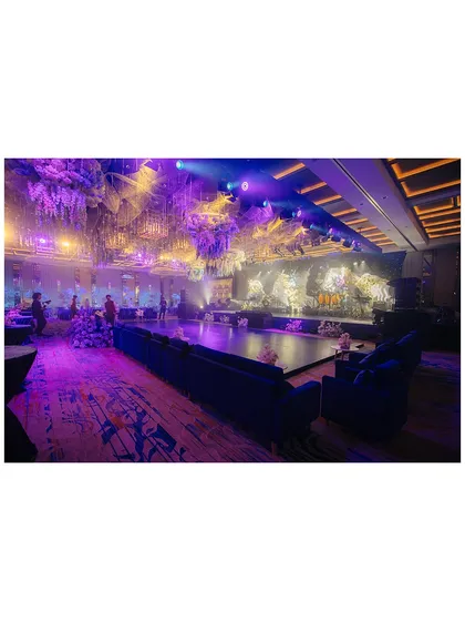 An overview of the stunning Sangeet venue in Phu Quoc. The purple and blue lighting, combined with elaborate floral decor, created a truly magical atmosphere.