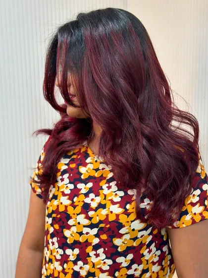 A side view of the cherry red balayage, showing how the color frames her face.