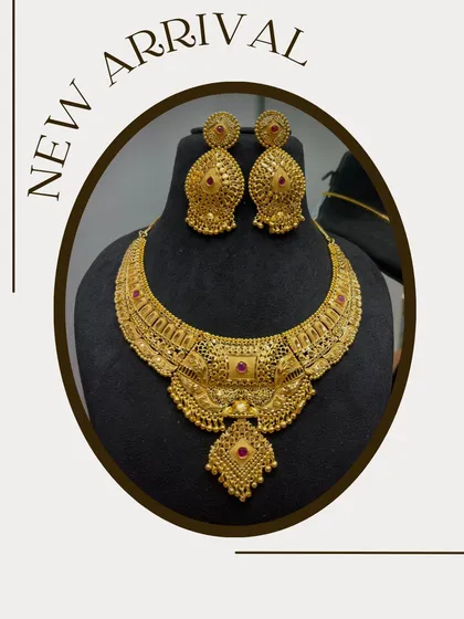 A new arrival in my choker collection. This is a heavy, gold-plated bridal choker with intricate work and ruby-colored stones, perfect for a traditional wedding look.