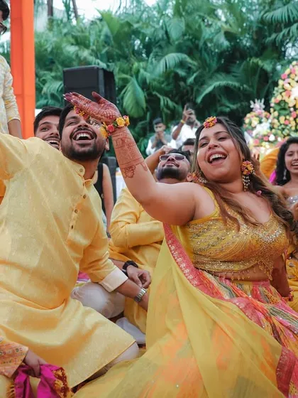 The bride and groom dancing with full energy at their Haldi party. We capture the uninhibited joy of these celebrations.