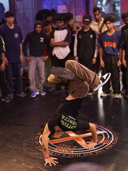 A b-boy mid-freeze, showcasing balance and strength. Our events draw a crowd that understands and appreciates the technical skill involved in breaking.