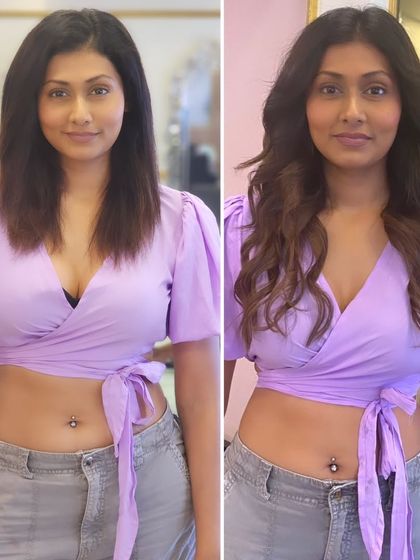 The same gorgeous 22-inch wavy transformation seen from the front. The extensions add volume and soft waves that perfectly frame her face.