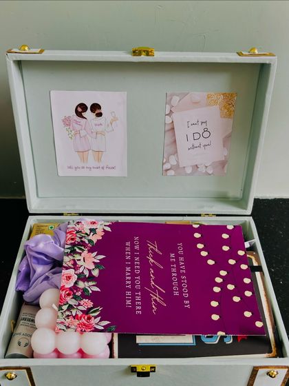 A look inside Medha's bridesmaid hamper. It includes a personal card, scrunchies, a bubble candle, and other treats to make her feel appreciated.