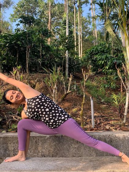 Extended Side Angle Pose in a lush, green environment. Yoga helps me connect with myself and the world around me.