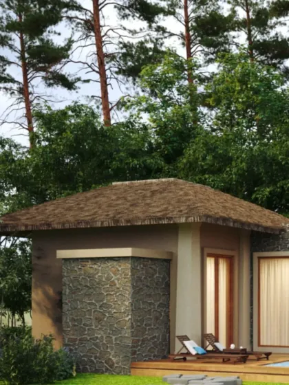A close-up of a cottage at Dev Villas, Kanha. The design uses locally sourced bamboo and rammed earth, offering a private pool and walled garden for a secluded experience in nature.
