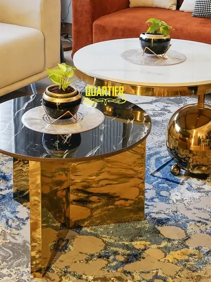 Detail shot of the unique nesting coffee tables at the Apex D'Rio project. The mix of polished gold metal, black marble, and white stone on a vibrant rug showcases my focus on materiality and texture.