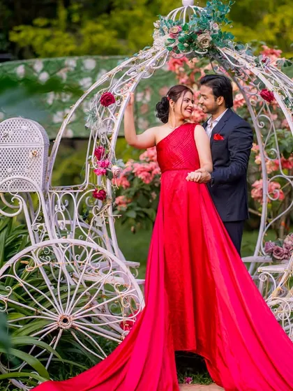 A happy and candid moment by the Cinderella carriage, surrounded by beautiful flowers.