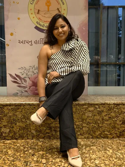 A relaxed and confident seated pose. Even when I am not on stage, I carry the poise and presence of a host.