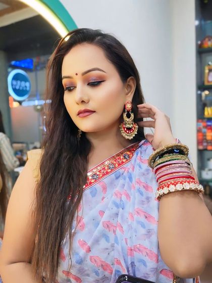 This angle shows the beautiful earrings and bangles that complete her party look.