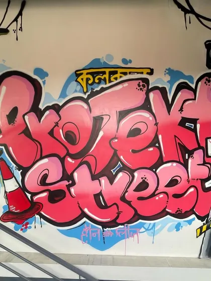 This vibrant, classic graffiti piece was created for the Projekt Street store in Kala Ghoda. The artwork features bold, bubble-style lettering and street-inspired elements like a traffic cone and signpost, giving the space an authentic urban vibe.