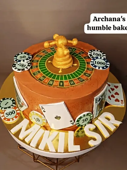 A casino-themed cake complete with a roulette wheel, playing cards, and poker chips.