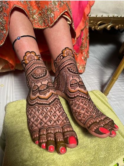 A beautiful shot of a traditional foot mehndi design. The patterns are dense and symmetrical, ensuring your feet look just as stunning as your hands.