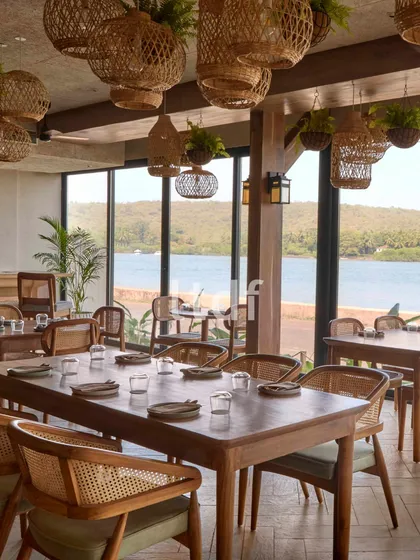 For this waterfront cafe, our design narrative was guided by serenity and nature. We used warm wood finishes and handcrafted rattan elements to evoke a sense of quiet, coastal luxury. The space is flooded with natural light, seamlessly blending the indoors with the lush landscape outside.
