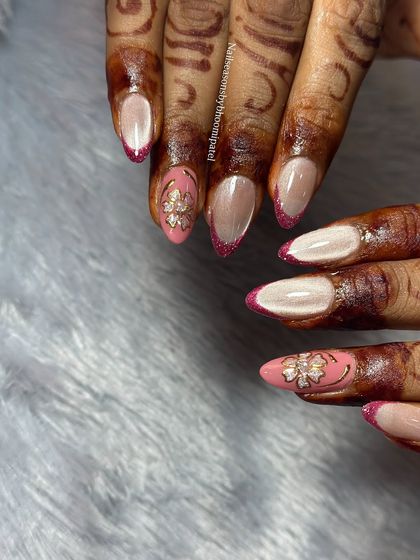A sophisticated bridal look featuring a cat eye base with reflective pink glitter on the tips and delicate 3D floral accents.