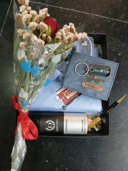 Another angle of the birthday gift hamper, showing the personalized denim accessories, shirt, and a fresh bouquet ready to be gifted.