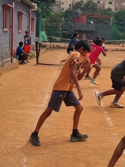 Young tennis players performing agility drills. This kind of training improves their footwork and reaction time on the court.