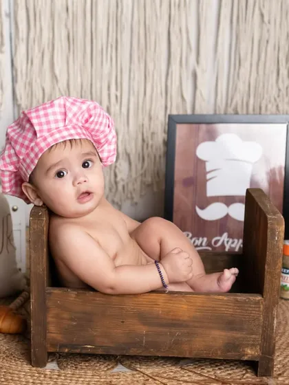 Our little chef is ready to take your order! I have so much fun with creative baby photo themes, and this kitchen setup with a tiny chef's hat is one of my absolute favorites.