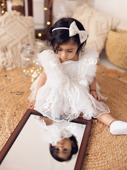 A curious moment as the birthday girl discovers her own reflection. We love capturing these sweet, unscripted moments of discovery.