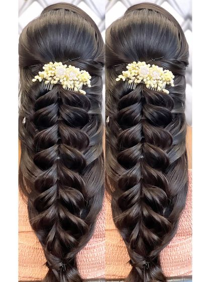 A simple yet elegant open hairstyle with a four-strand braid, decorated with a floral comb.