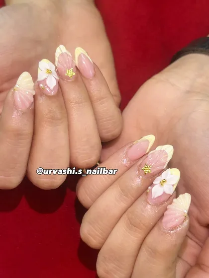 Inspired by the sea, this set features hand-sculpted shell textures on the tips and delicate 3D flowers with gold bead centers. The combination of textures on a soft blush base creates a truly unique and elegant manicure.