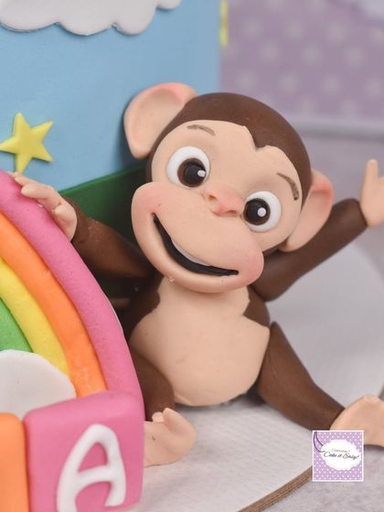 Here's the cheeky monkey from the Cocomelon cake, waving hello from behind a rainbow. Each animal figurine is sculpted with its own unique personality.