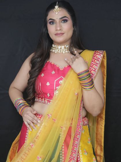 A beautiful portrait in the Haldi outfit, showing the vibrant colors and the traditional Kundan jewellery.