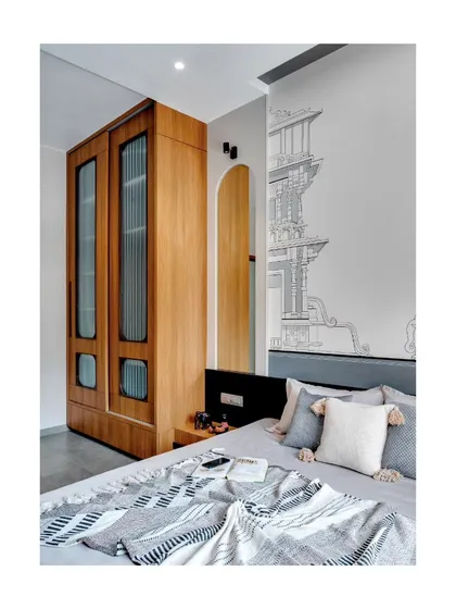 A detail of the custom wardrobe and the wall mural, showcasing the blend of modern functionality and personalized art.