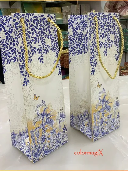 Our elegant bottle bags in the blue and gold floral print are perfect for gifting beverages or other tall items in style.