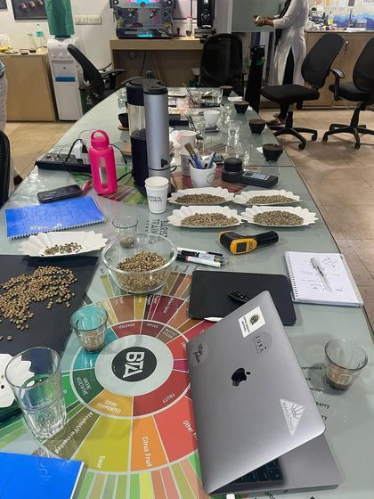 This is our classroom. A full setup for a roasting and cupping session, complete with a flavor wheel, scales, and various beans.