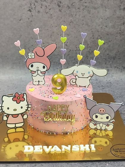 A super cute, non-fondant Sanrio Candyland cake. This pink cake features Hello Kitty, My Melody, and other characters, decorated with pastel hearts and sprinkles.