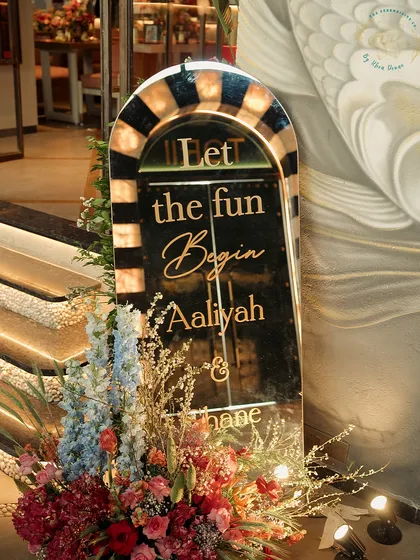 A custom welcome sign for a mehndi party. The elegant script and floral accents set a festive and personal tone right from the entrance.