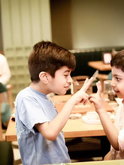 Two friends engaged in a playful game. We capture the fun and friendships that make birthday parties so memorable.