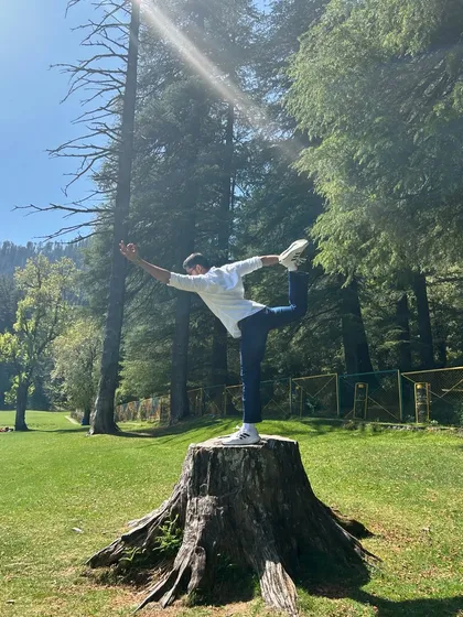 Performing Natarajasana (Dancer's Pose) in the beautiful meadows of Khajjiar. The fresh mountain air and open space make every breath and movement feel more alive.