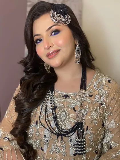 This client looks absolutely regal. The bold makeup and statement jewelry create a look that is powerful and beautiful.