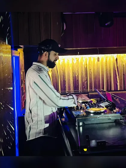 A side profile of me mixing during a set. This view shows the professional-grade turntables and mixer I use for all my performances.
