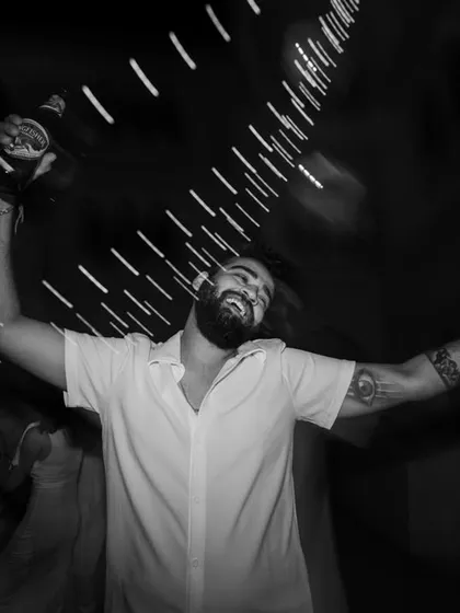 The pure energy of a party captured in a motion-blurred, black and white frame. This artistic approach conveys the feeling and vibe of the moment, not just the visual details.