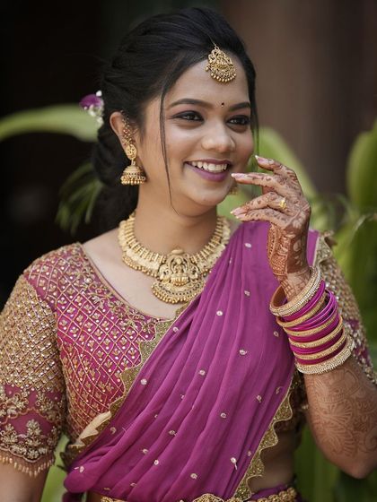 A joyful, smiling shot of Teju. Her makeup is fresh and bright, capturing her happiness on her special day.